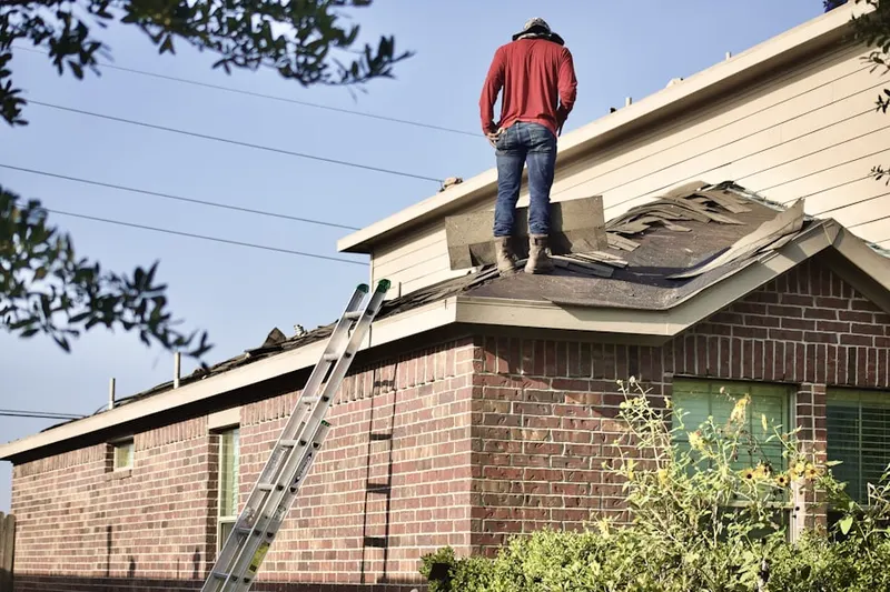 Professional roofer working on a residential roof in Kenwood Farm Estates